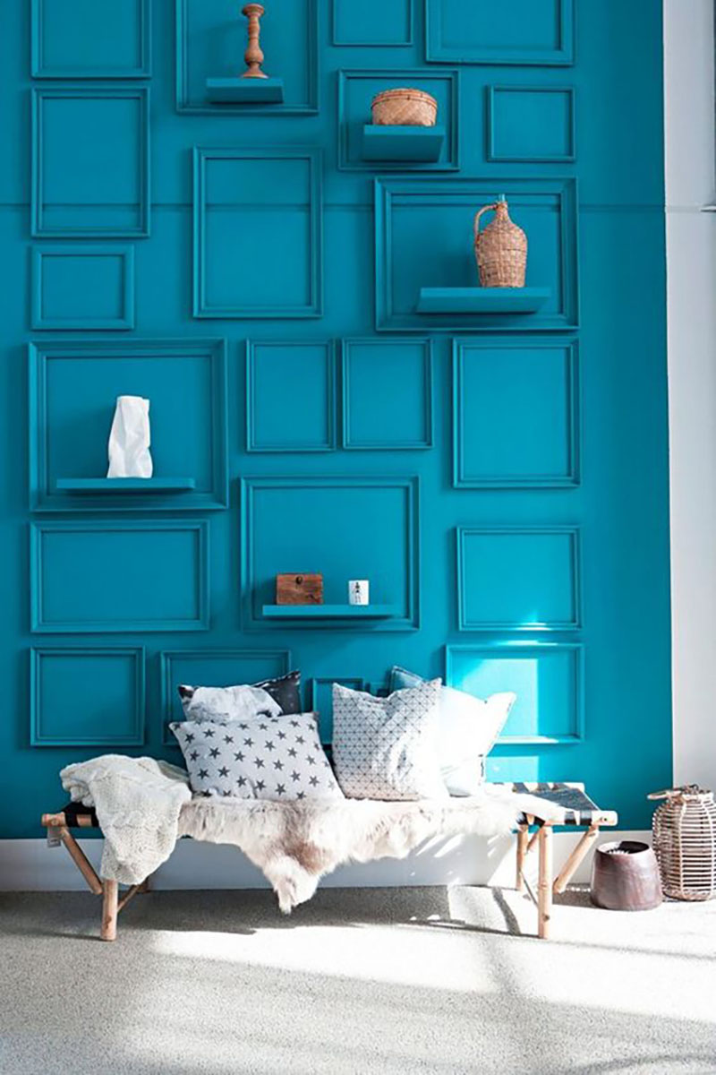 Turquoise wall color with the same colored picture frames and a few shelves in turquoise too.