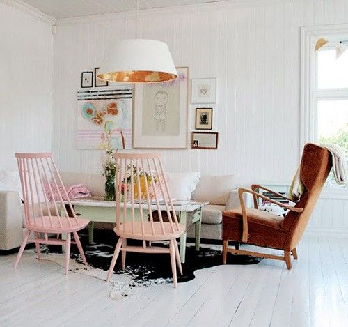 Pink chairs and a rusty armchair look good together.