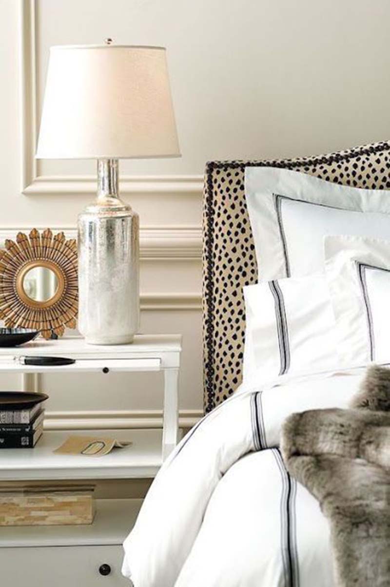 Headboard with animal pattern looks good in this white interior.
